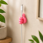 Thumb wire holder holding USB cable on wall lifestyle